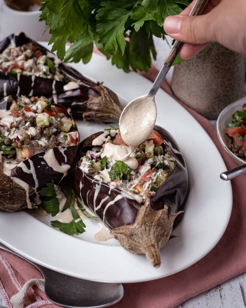 Découvrez cette recette d'aubergines farcies aux légumes du soleil et aux lentilles, avec une sublime sauce bien crémeuse au tahini :) Cette recette est vegan et sans gluten !